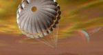 A Cassini űrszonda leszállóegységét ábrázoló grafika azt mutatja, ahogy a Huygens fékezőernyőjével a Szaturnusz hatalmas holdja, a Titán felé közelít (Fotó: NASA)